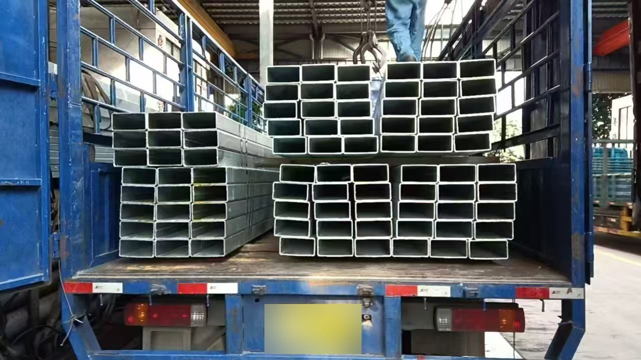 Galvanized square and rectangular steel tubes bundled on a truck