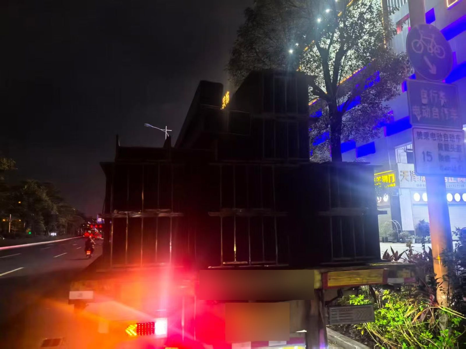 H beam shipment on a truck heading to the container port at night