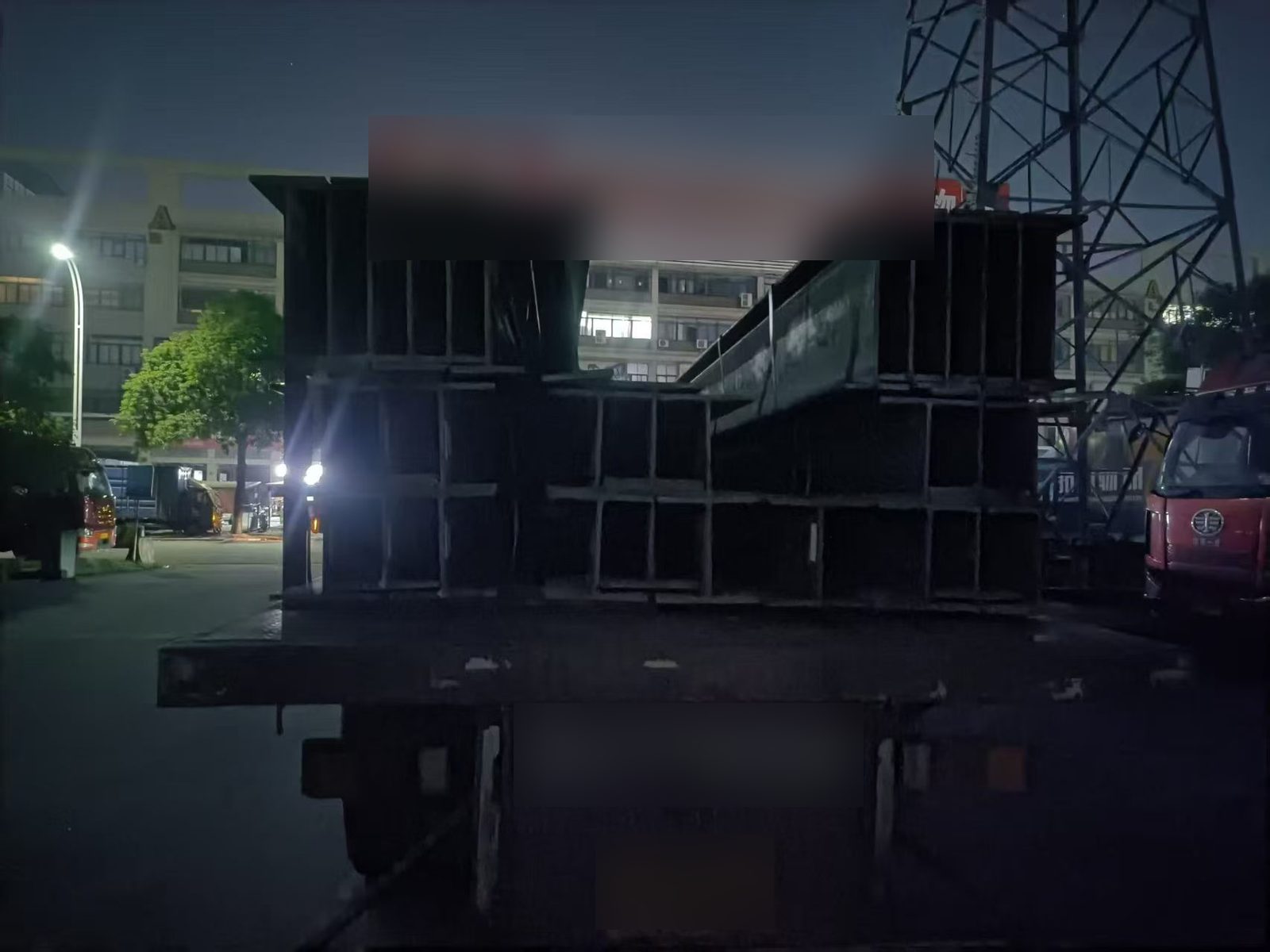 Oversize H beam bundles transported by night through Foshan