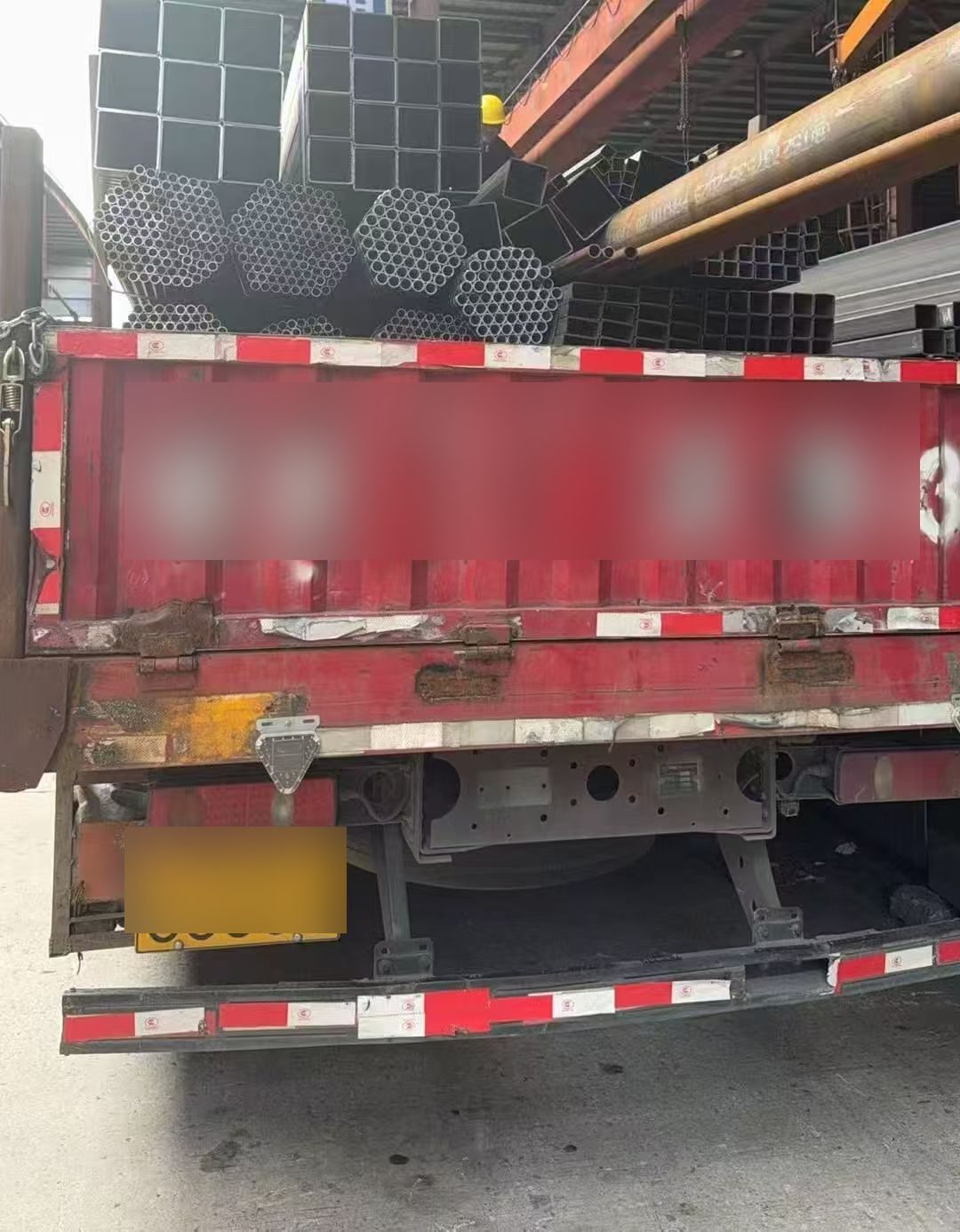 Truck loaded with round tubes and square hollow sections for delivery