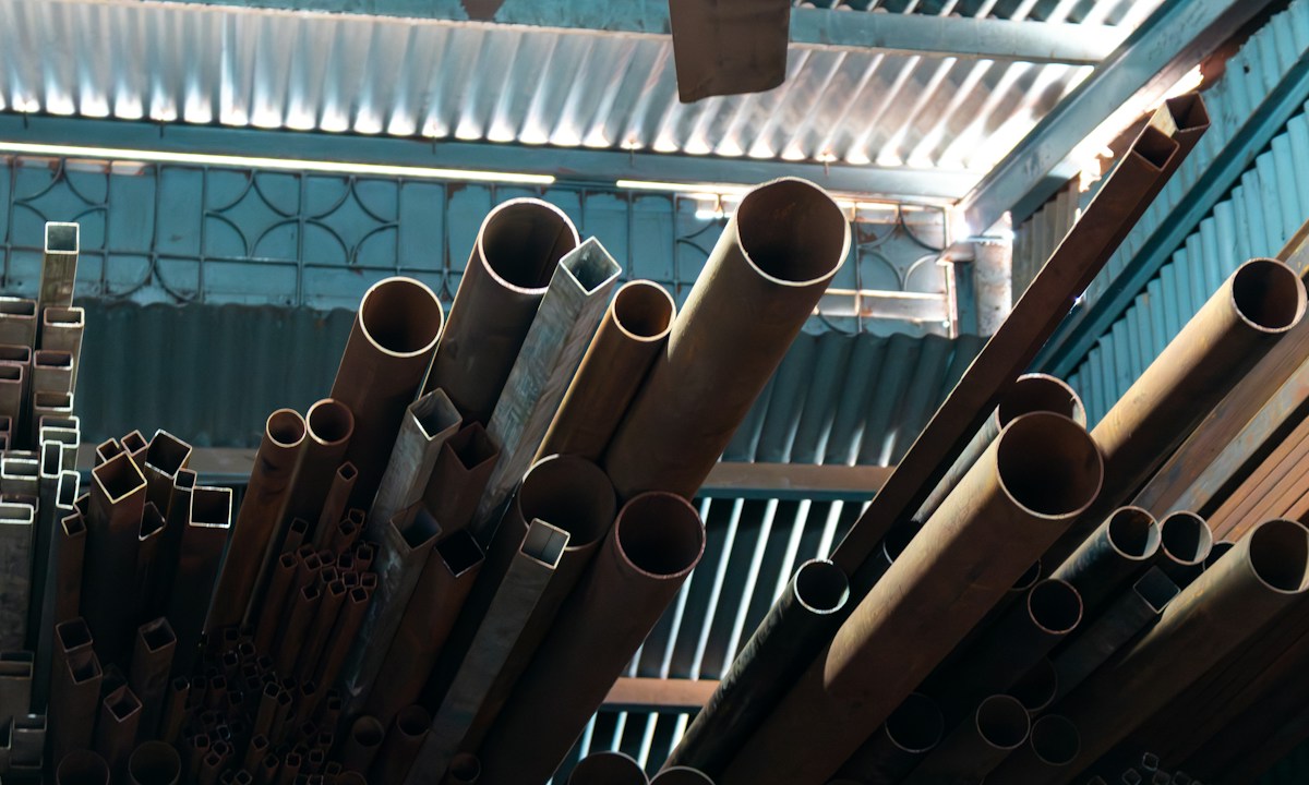 Steel pipes and square tubes stacked in a warehouse